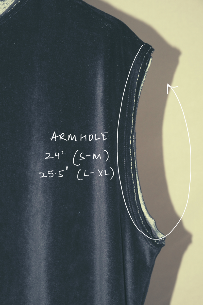 Black sleeveless top with armhole measurements labeled on a beige background