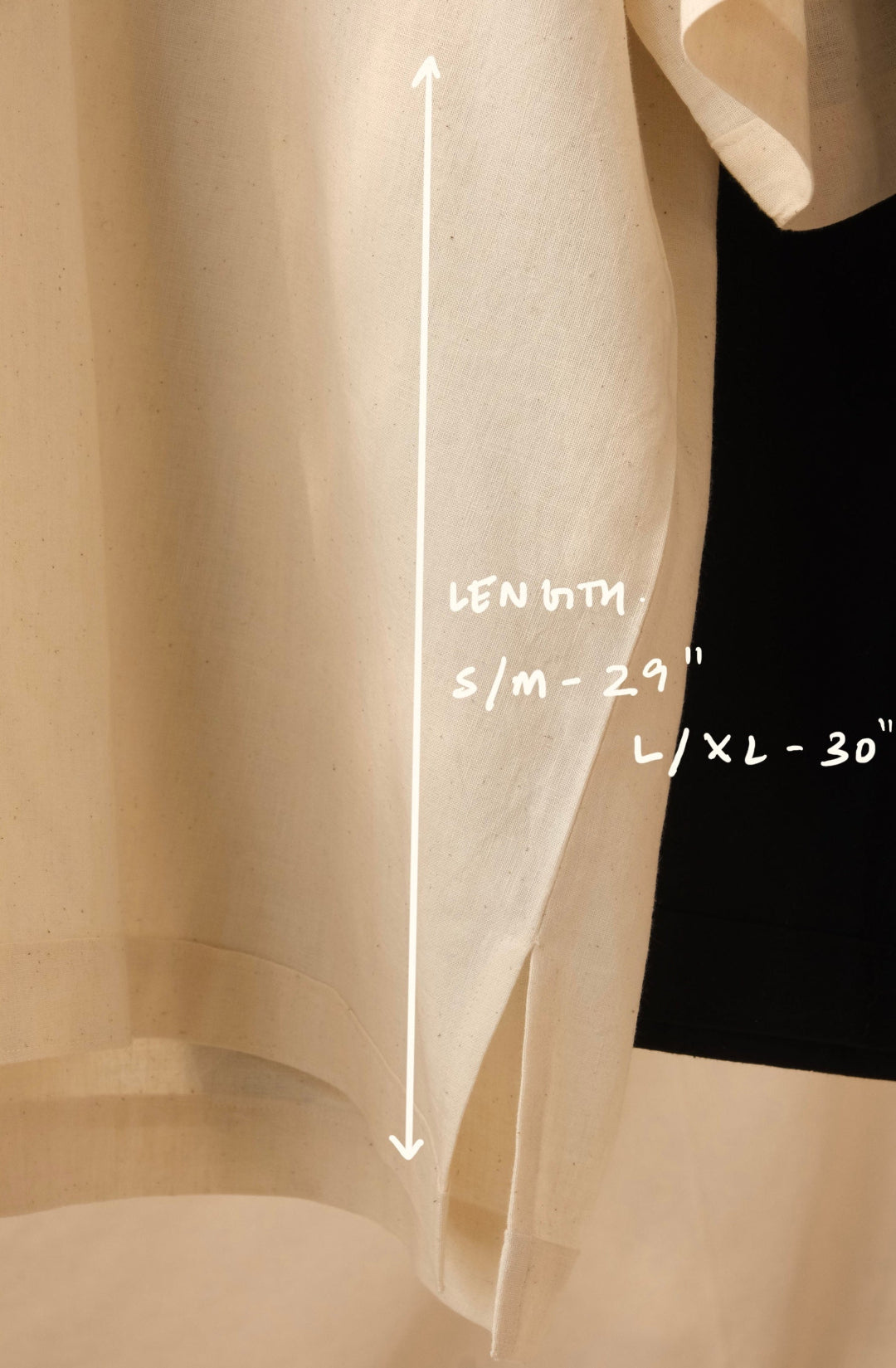 Beige shirt with measurements indicated on a plain background