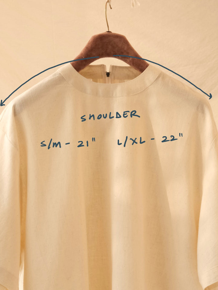 Beige sweatshirt on a hanger with shoulder measurement text